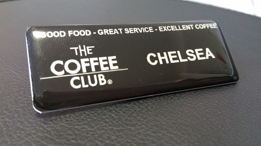 Black domed name badge with logo